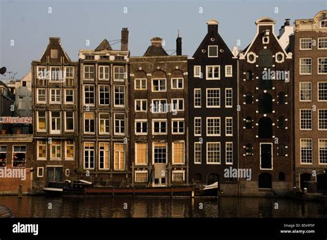 Old canal houses, Damrak, Amsterdam Stock Photo - Alamy