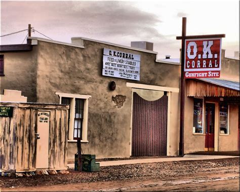 an old western town with signs on the building and other buildings in ...