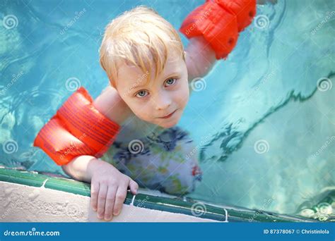 Cute Young Child with Arm Floaties in Swimming Pool Stock Image - Image ...