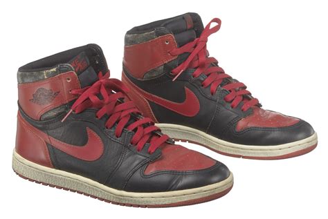 Pair of red and black Air Jordan I high top sneakers made by Nike ...