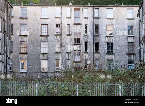 Derelict council house in poor housing estate slum with many social ...