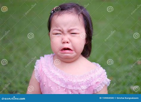 Funny Face Of A Sad Little Girl Crying And Frowning Stock Photo ...