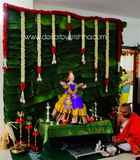 a man sitting in front of a green stage with decorations on it's sides