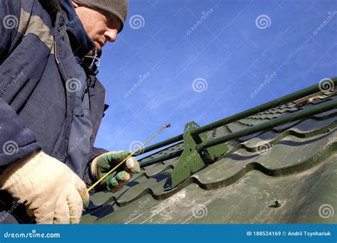 Installation by the Master on a Roof of the House of Snow Stops ...