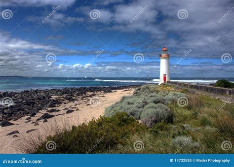 Port fairy lighthouse stock photo. Image of rocks, cloudy - 14732550