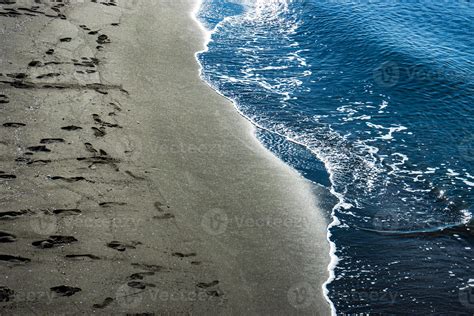 Black volcanic sand beach and sea 4954747 Stock Photo at Vecteezy