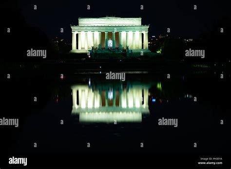 Outside view of Lincoln Memorial at night with reflection from pool ...