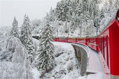 The Bernina Express adds a splash of red to snow-covered Switzerland ...