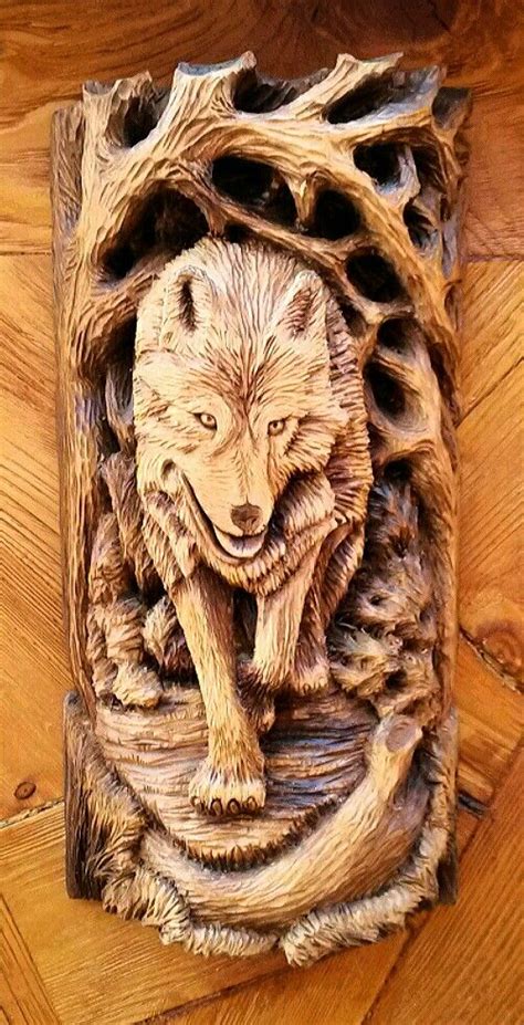 a wooden carving of a wolf in the woods