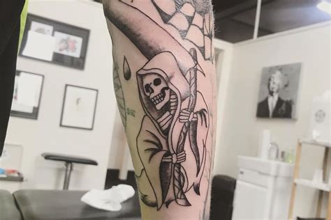 Grim Reaper With Skulls Tattoo