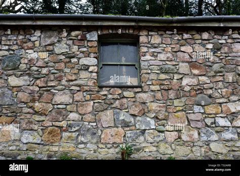 Rubble masonry Stone building with green wooden sash window in ...