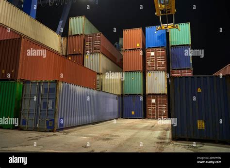 operation of container terminal at night. Unloading container ship at ...