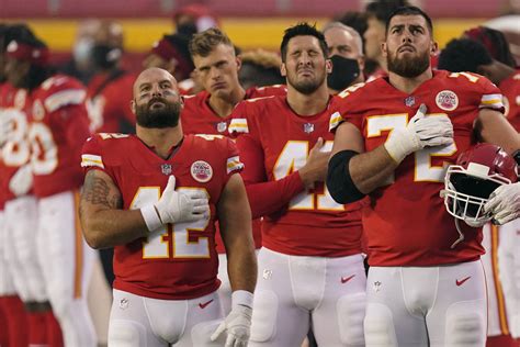 Kansas City Chiefs players stand for the national anthem before an NFL ...