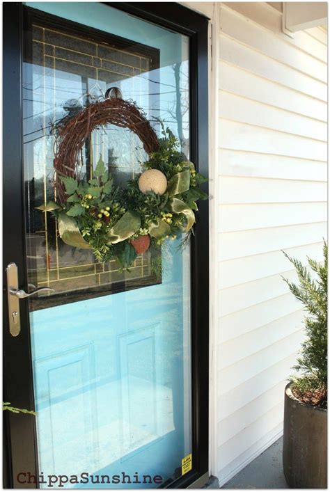 a wreath hanging on the front door of a house