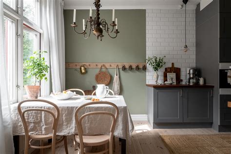 Grey kitchen cabinets against sage green walls in an attic apartment ...