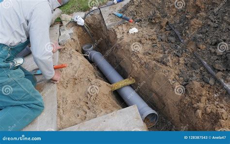 Laying and Installation of a Sewer Pipe Stock Image - Image of plumber ...