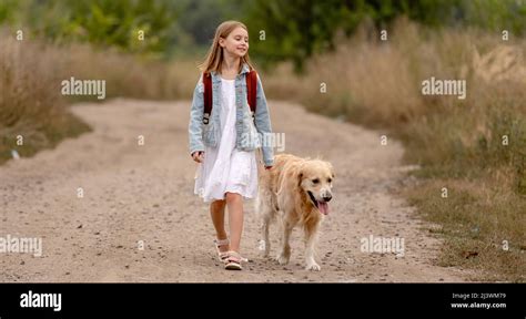 Girl with golden retriever dog Stock Photo - Alamy