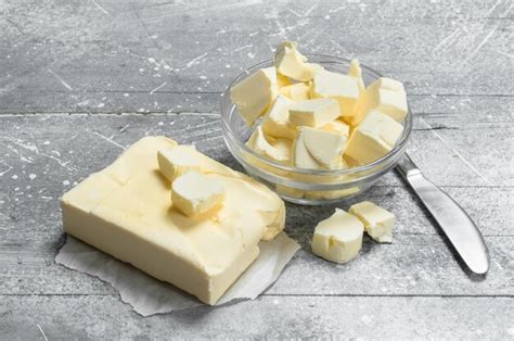 Premium Photo | Butter in a glass bowl with a knife