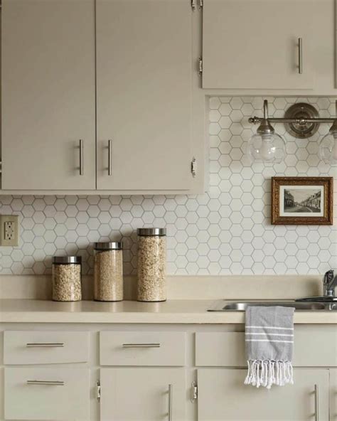 White Hexagon Tile Backsplash With Taupe Cabinetry - Soul & Lane