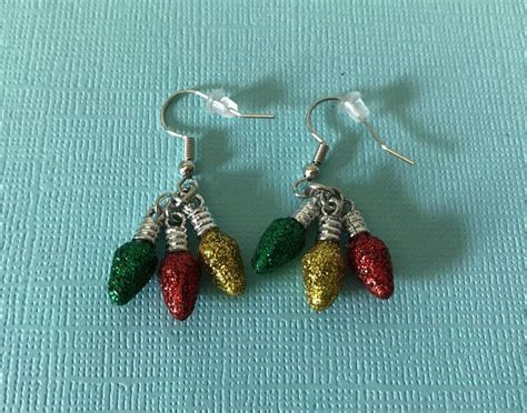 two pairs of earrings with red, green and yellow christmas lights ...