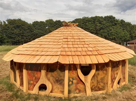 Wooden shelter decorated with rainbow and children's handprints ...