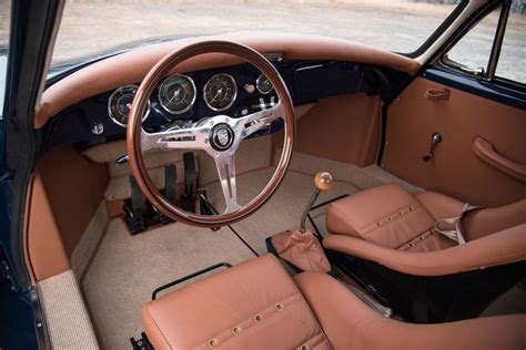 the interior of an old car with tan leather seats and steering wheel ...