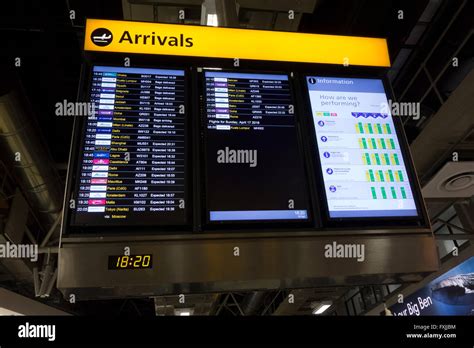 Arrivals screen at Heathrow terminal 4 Stock Photo - Alamy