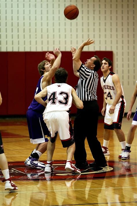 referee tossing the ball upward jumpball basketball game free image ...