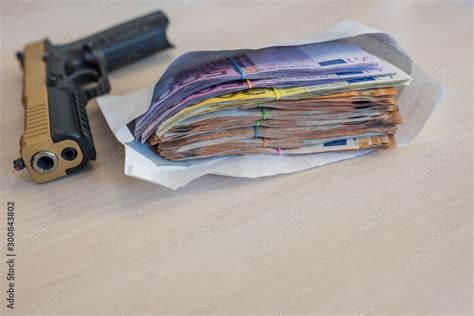 Black and gold gun pistol and money euros background Stock Photo ...