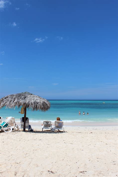 Cuba - Guardalavaca. A perfect day at the beach. Shaded under a palappa ...