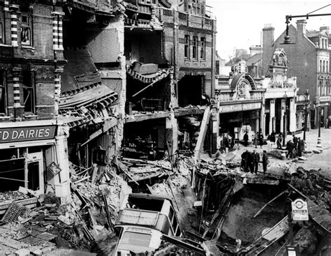 WWII. A bus lies in a bomb crater after a German night air raid during ...