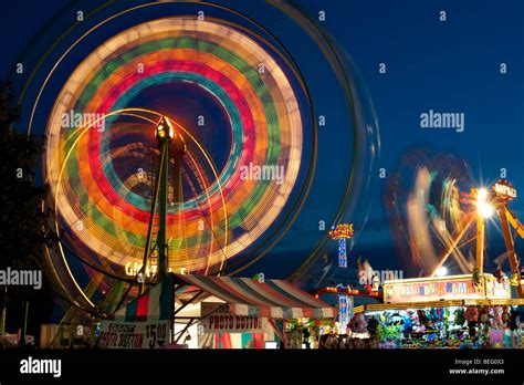 Evergreen State Fair at twilight with Ferris Wheel and amusement rides ...