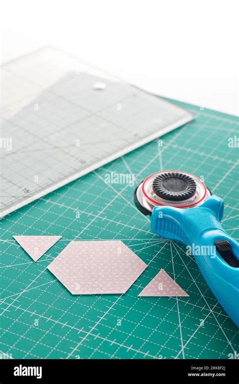 The process of cutting pieces of fabric in the shape of hexagons to ...