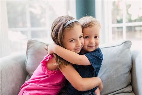 "Brother And Sister Hugging On A Big Chair" by Stocksy Contributor ...