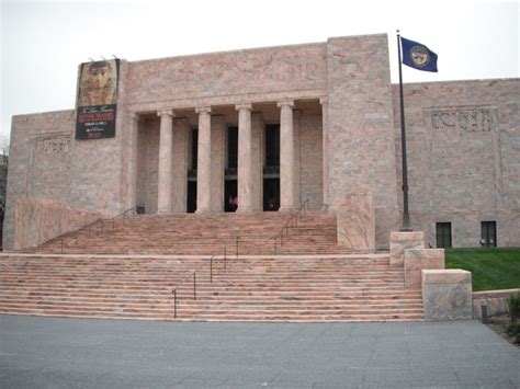 a large building with steps leading up to it and a flag flying in the air