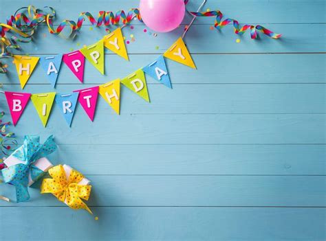 a birthday banner with balloons, streamers and confetti on a blue ...