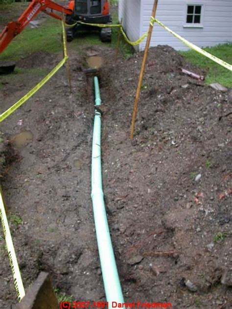 installing a new sewer line: placing the septic or sewer pipe in the trench