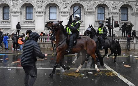 London protesters clash with police as thousands around world defy ...