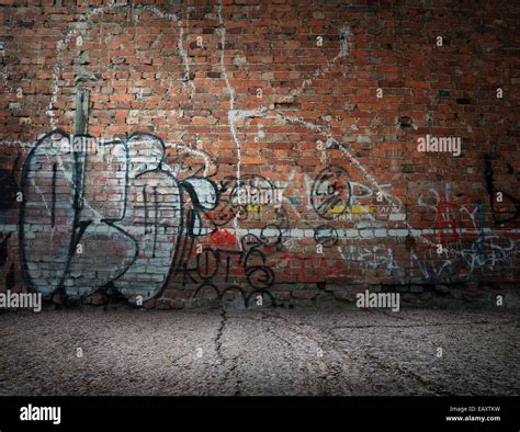 Graffiti on the old wall of red brick Stock Photo - Alamy