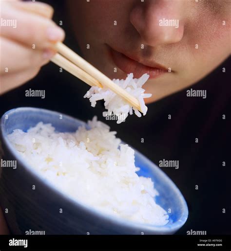 A Person Eating Rice with Chopsticks FoodCollection Stock Photo - Alamy