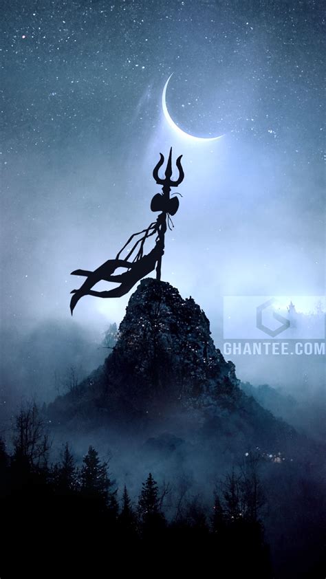 a statue on top of a mountain with the moon in the sky and stars above it