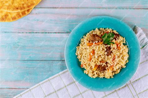 Premium Photo | Arabic dish with rice, meat, carrot and pita bread