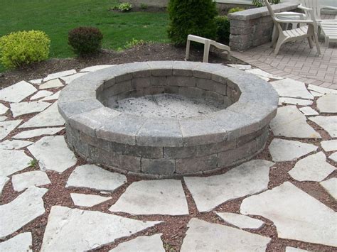 Firepit with smooth stone wall | Fire pit materials, Fire pit, Outdoor ...