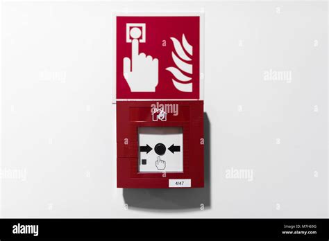 Red Fire alarm button on white wall Stock Photo - Alamy