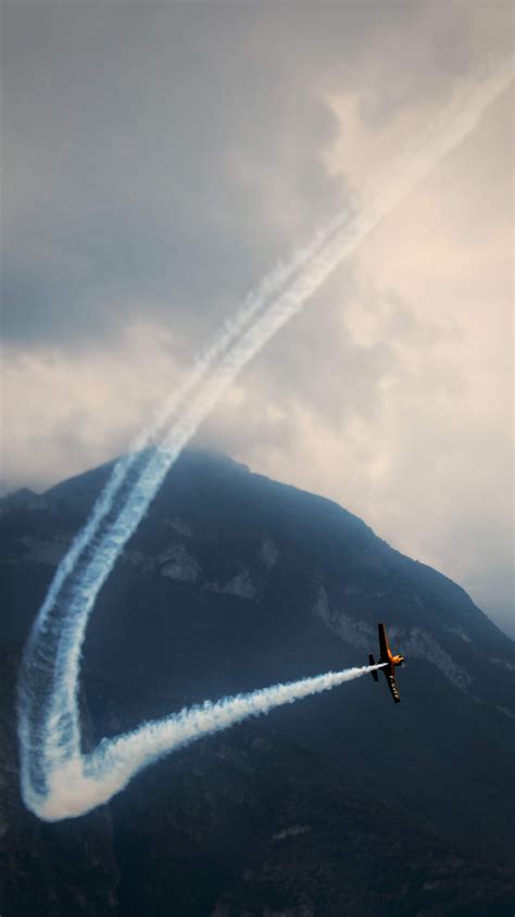 Small plane flying over mountains · Free Stock Photo