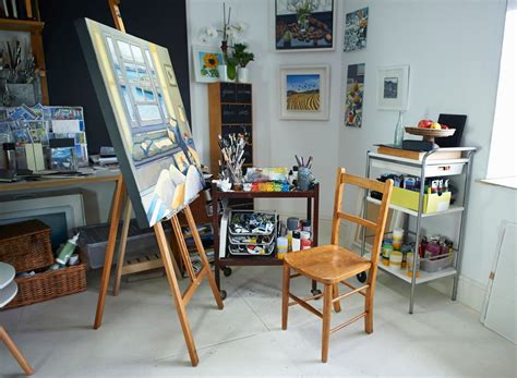 an artist's studio with easel, canvass and other art supplies in it