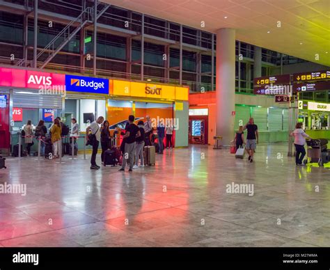 Car rental booths in the arrivals hall at Alicante Airport at night ...