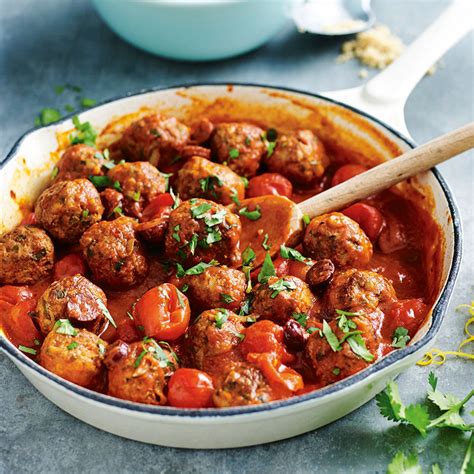 meatballs and tomatoes in a tomato sauce with parsley