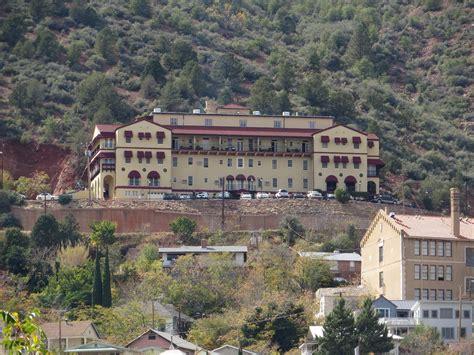 a large yellow building sitting on the side of a hill next to some ...