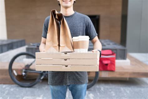 Young Delivery Man with Food Parcel Stock Image - Image of midsection ...